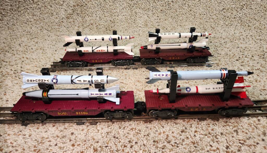 four model flatcars with rockets on top