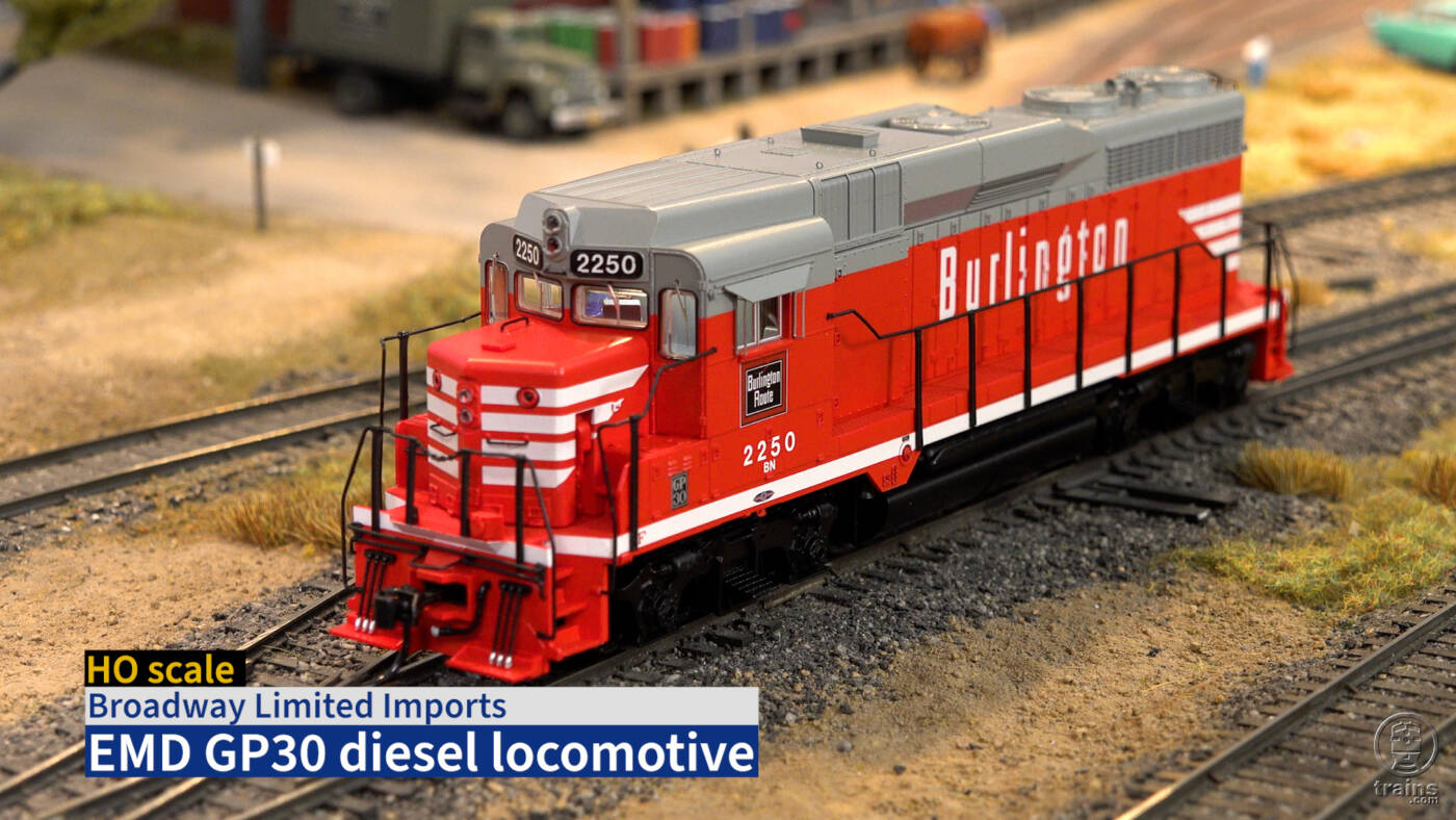 Screen capture from video with red and gray HO scale diesel locomotive and title bar.