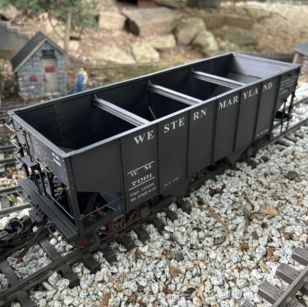 close up of model hopper car on garden railway