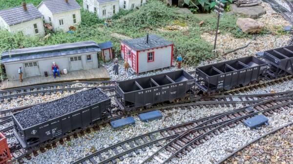 hopper cars on track of garden railway