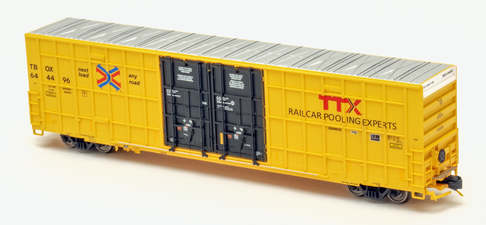 Color photo of N scale boxcar painted yellow and black with silver roof.