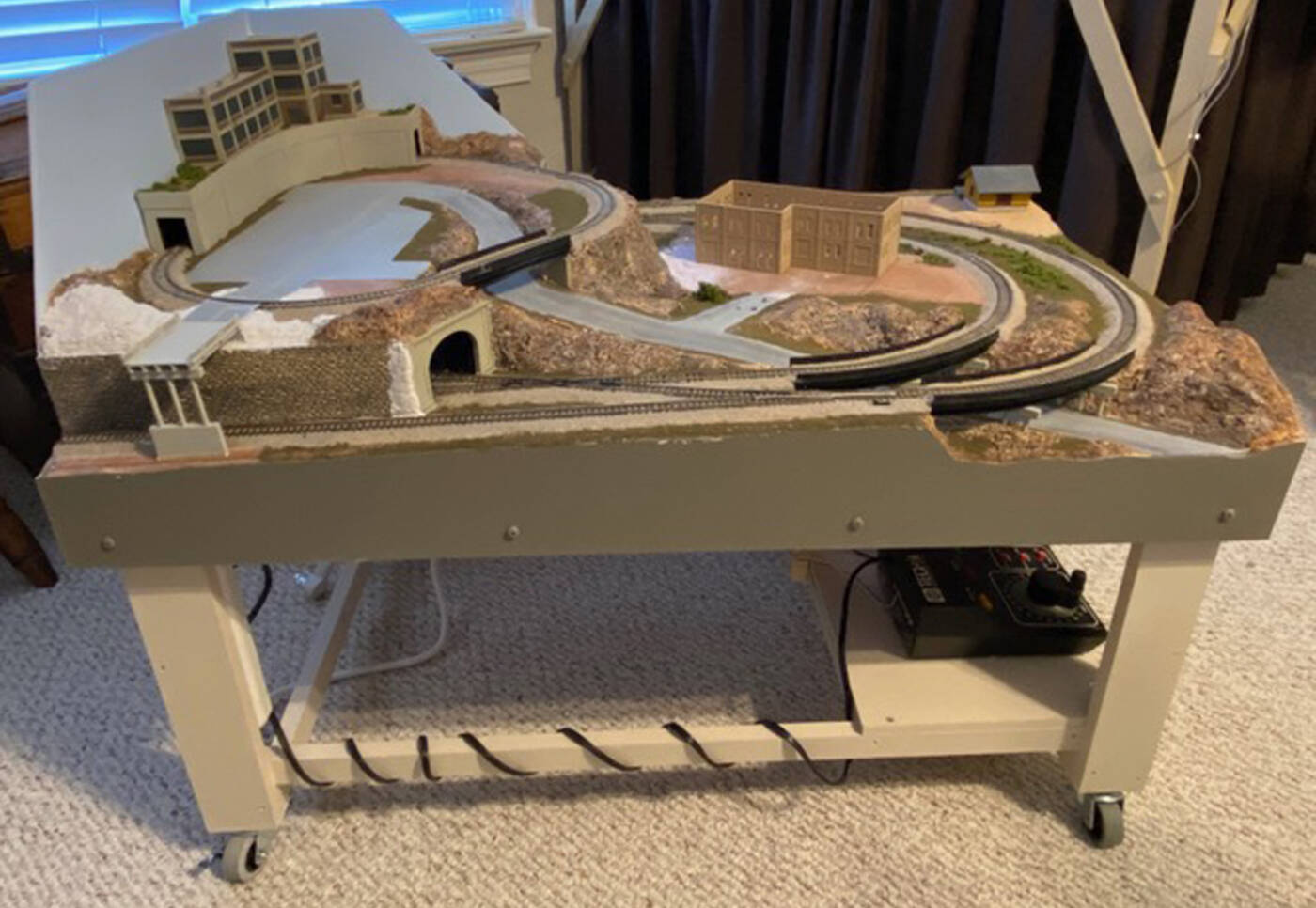 A mostly completed model railroad layout viewed from the side