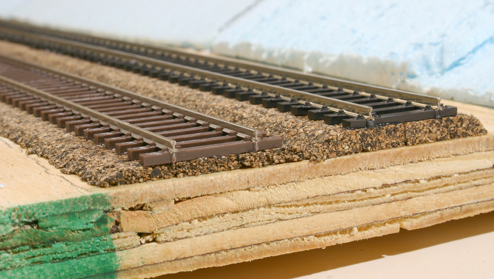 Color image of track on cork roadbed attached to plywood.