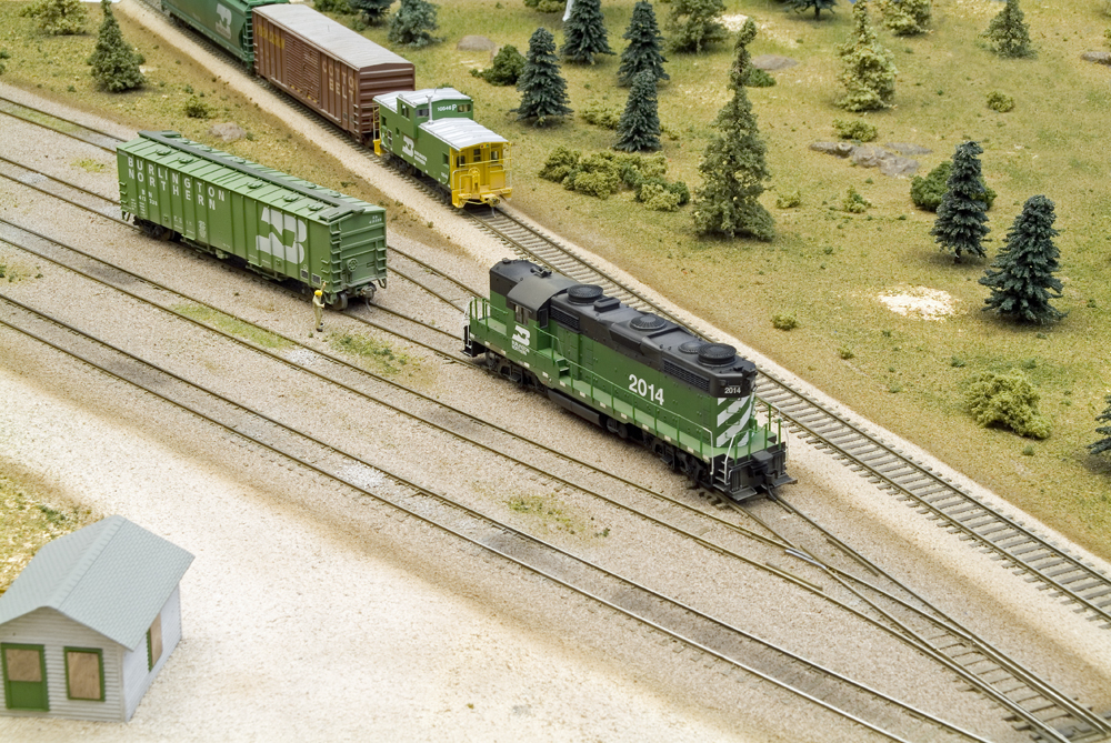 Color photo of yard scene on HO scale diorama with locomotives and rolling stock.