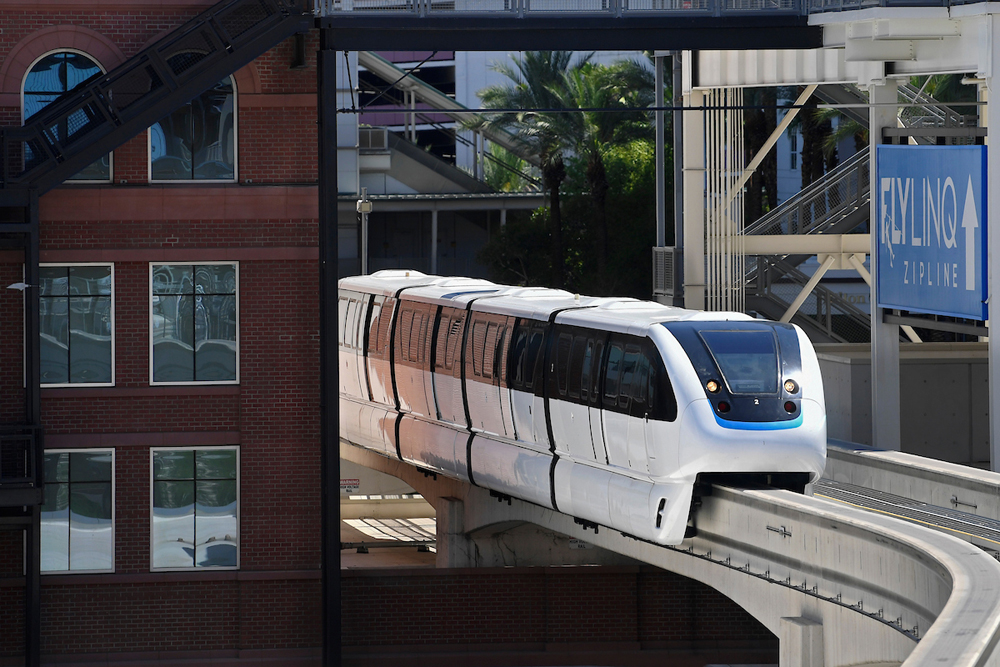 White monorail on route between buildings