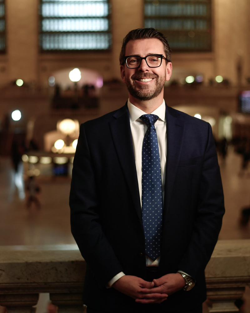 Man in suit on balcony at Grand Central Terminal