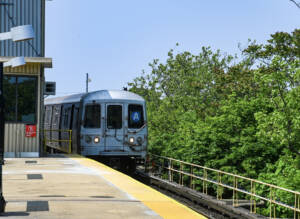 Subway train arrives at above-ground station