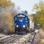 Nose-on view of train led by blue locomotive