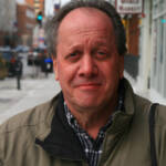 Head shot of man on city sidewalk