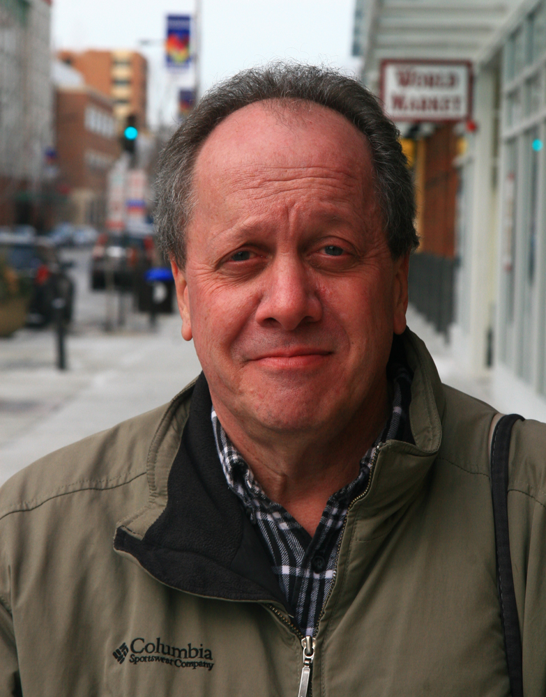 Head shot of man on city sidewalk