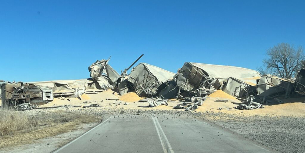 Derailed grain hoppers blocking road crossing