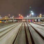 A nighttime photo of multiple tracks leading to Chicago Union Station