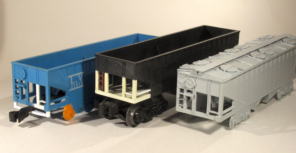 three plastic model pieces of rolling stock