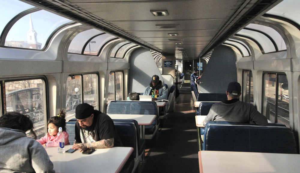 Interior of passenger car with curving glass windows at roofline