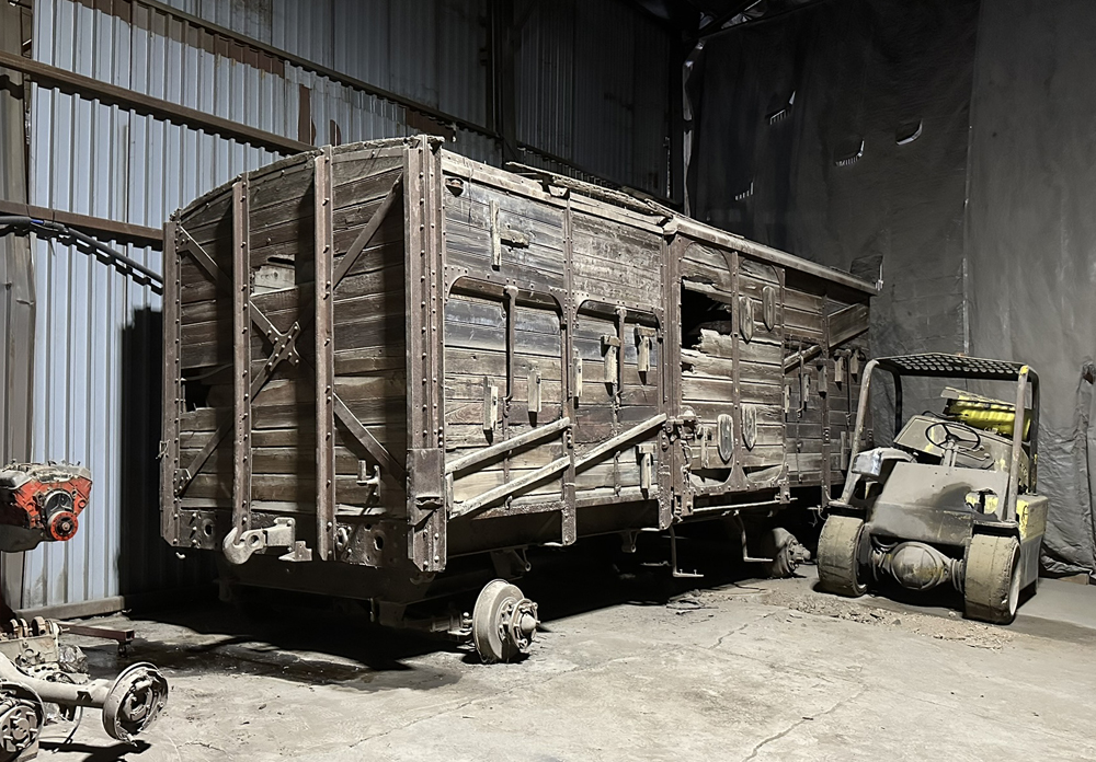 Weathered wooden boxcar in warehouse