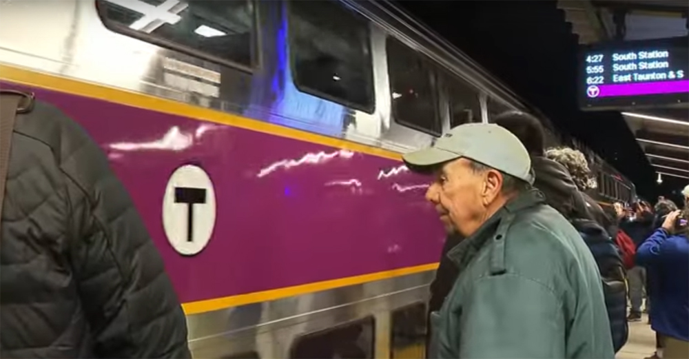 People standing on platform waiting to board commuter train