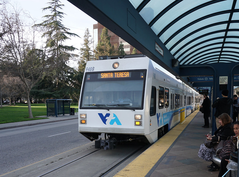 White light rail train at station